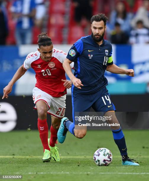 Tim Sparv of Finland runs with the ball whilst under pressure from Yussuf Poulsen of Denmark during the UEFA Euro 2020 Championship Group B match...