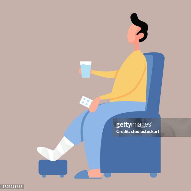 caucasian man with broken leg sitting on the armchair - medical illustration stock illustrations
