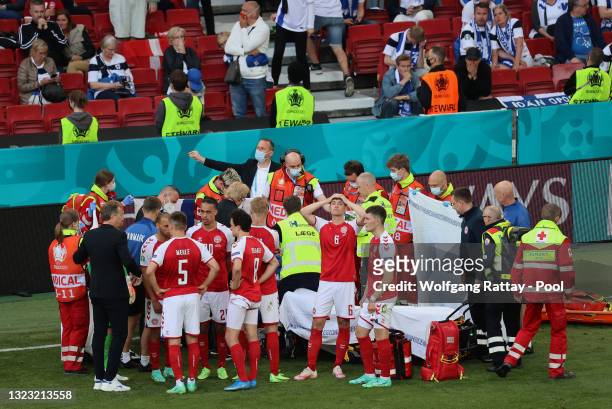 Andreas Christensen of Denmark looks dejected whilst team mate Christian Eriksen receives medical treatment during the UEFA Euro 2020 Championship...