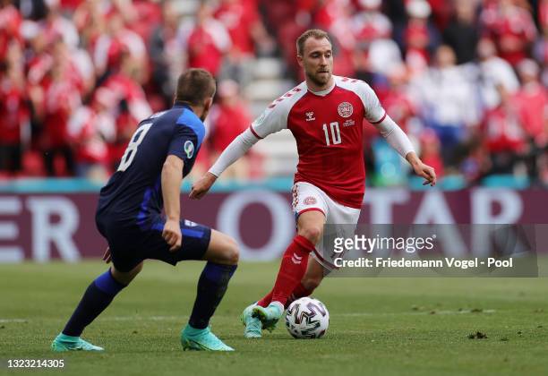 Christian Eriksen of Denmark runs with the ball during the UEFA Euro 2020 Championship Group B match between Denmark and Finland on June 12, 2021 in...