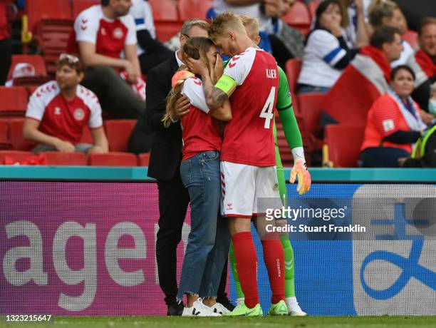 Sabrina Kvist Jensen, Girlfriend of Christian Eriksen of Denmark looks dejected as she is consoled by Simon Kjaer of Denmark whilst Christian Eriksen...