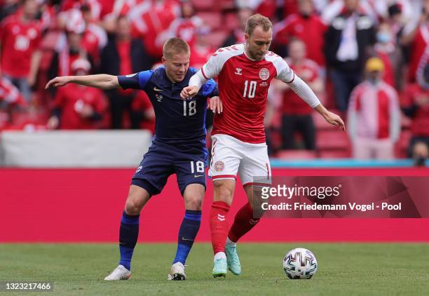 Christian Eriksen of Denmark battles for possession with Jere Uronen of Finland during the UEFA Euro 2020 Championship Group B match between Denmark...