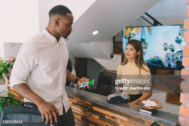 businessman checking in with covid-19 vaccine certificate - lobby screen stock pictures, royalty-free photos & images