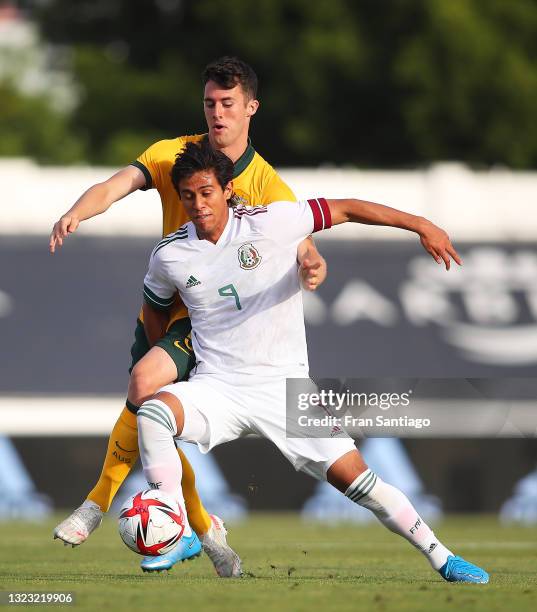 José Juan Macías Guzmán of Mexico competes for the ball with Dylan Ryan of Australia during a International Friendly match between Mexico and...