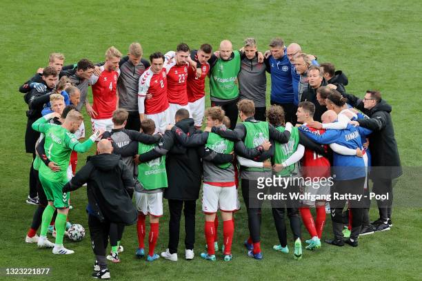 The Denmark team form a huddle before play restarts during the UEFA Euro 2020 Championship Group B match between Denmark and Finland on June 12, 2021...