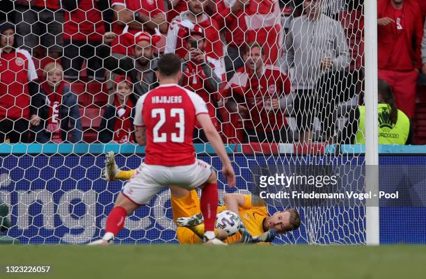Lukas Hradecky of Finland saves a penalty taken by Pierre-Emile Hojbjerg of Denmark during the UEFA Euro 2020 Championship Group B match between...