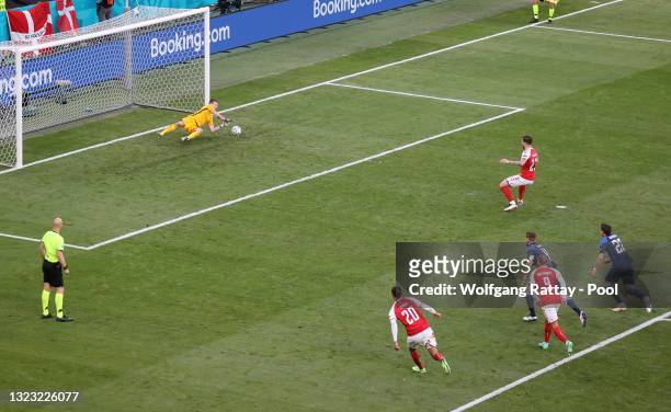 Pierre-Emile Hojbjerg of Denmark has a penalty saved by Lukas Hradecky of Finland during the UEFA Euro 2020 Championship Group B match between...