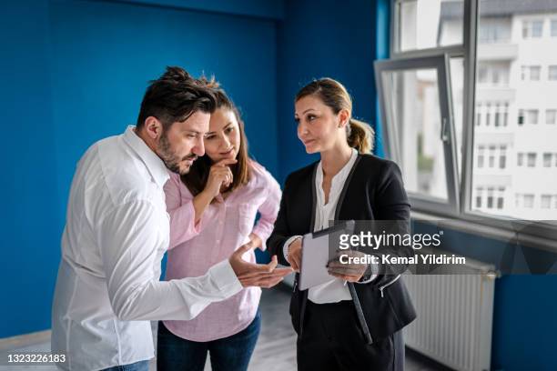 real estate agent and young couple making deals for property - corporate business transaction stock pictures, royalty-free photos & images