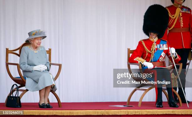 Queen Elizabeth II accompanied by Prince Edward, Duke of Kent attends a military parade, held by the Household Division in the Quadrangle of Windsor...