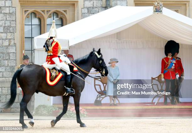 Queen Elizabeth II accompanied by Prince Edward, Duke of Kent attends a military parade, held by the Household Division in the Quadrangle of Windsor...