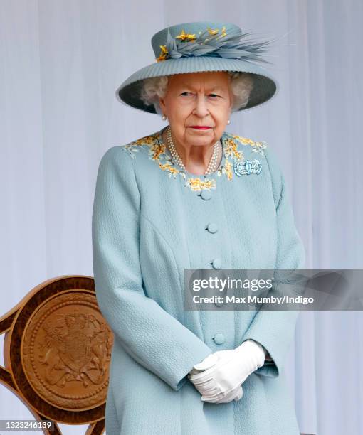 Queen Elizabeth II attends a military parade, held by the Household Division in the Quadrangle of Windsor Castle, to mark her Official Birthday on...