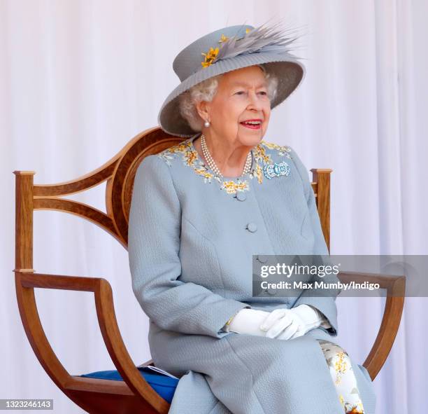 Queen Elizabeth II watches a flypast by the RAF Red Arrows as she attends a military parade, held by the Household Division in the Quadrangle of...