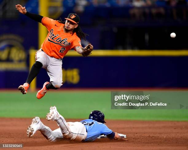 Freddy Galvis of the Baltimore Orioles misses the ball as Kevin Kiermaier of the Tampa Bay Rays steals second base during the eighth inning at...