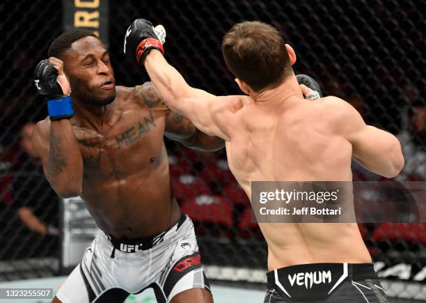 Movsar Evloev of Russia punches Hakeem Dawodu of Canada in their featherweight fight during the UFC 263 event at Gila River Arena on June 12, 2021 in...