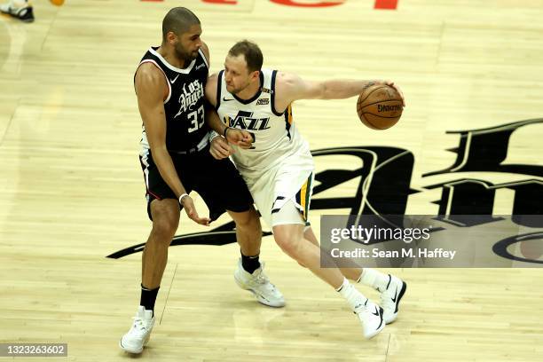 Nicolas Batum of the LA Clippers defends against the dribble of Joe Ingles of the Utah Jazz during the first half of a game at Staples Center on June...