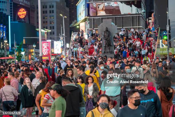 Large crowds of people with and without masks fill Times Square on June 12, 2021 in New York City. New York Governor Andrew Cuomo announced pandemic...