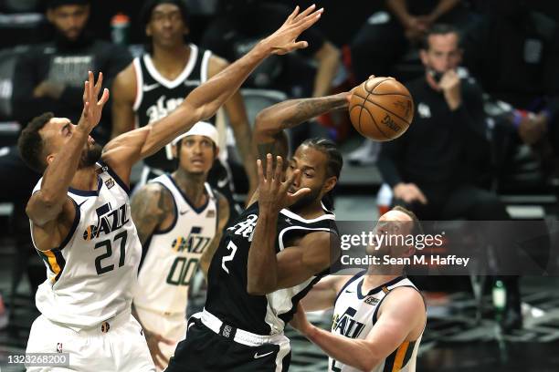 Rudy Gobert and Joe Ingles of the Utah Jazz defend against Kawhi Leonard of the LA Clippers during the second half of a game at Staples Center on...