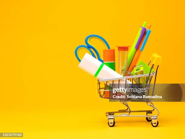 school supplies in shopping cart - immobile ストックフォトと画像