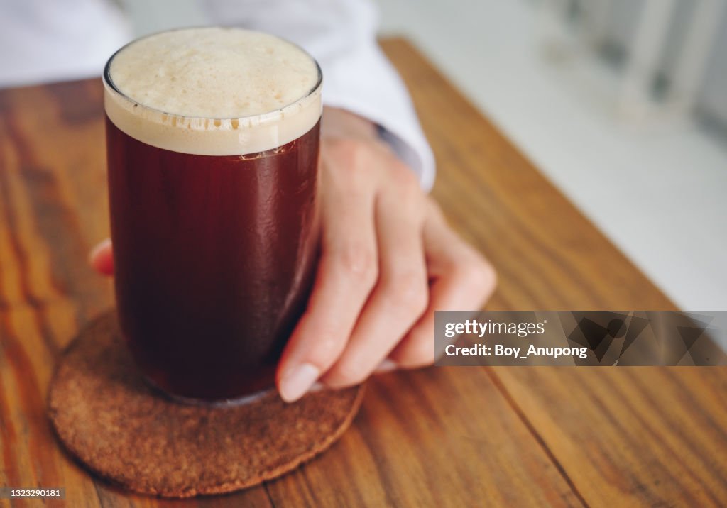 A Nitro cold brew coffee on the wood table in cafe shop.