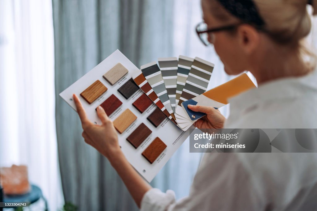 Young Woman Choosing Colour Palette For New Flat