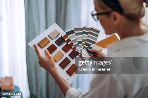 Young Woman Choosing Colour Palette For New Flat Young Woman Choosing Colour Palette For New Flat