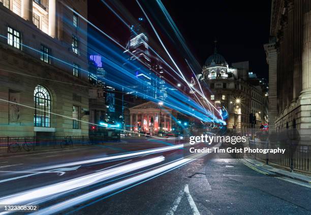 the city of london at night with light trails - digital business london stockfoto's en -beelden