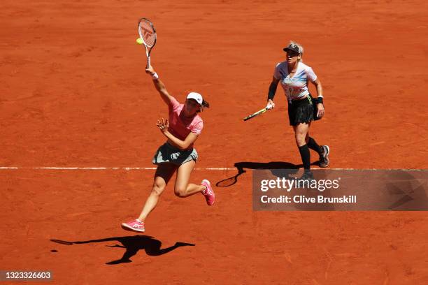 Iga Swiatek of Poland, playing partner of Bethanie Mattek-Sands of The United States plays a forehand smash in their Women's Doubles Final match...