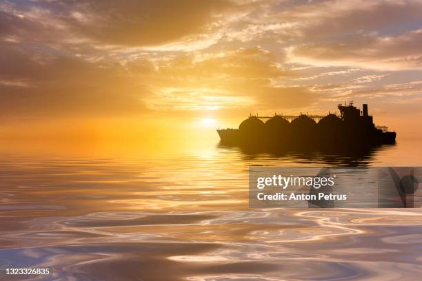 lng carrier in the sea at sunset. world oil and gas industry - navire citerne photos et images de collection