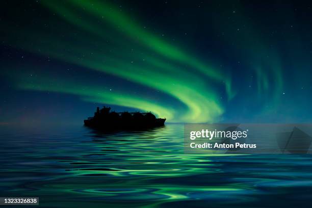 lng carrier on the background of the northern lights. world oil and gas industry - gas storage stockfoto's en -beelden