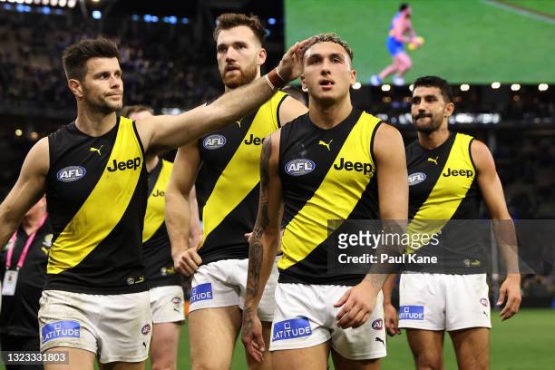 Trent Cotchin of the Tigers consoles Shai Bolton while walking from the field after being defeated during the round 14 AFL match between the West...