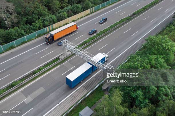 truck toll system on highway - control gantry, aerial view - tolls stock pictures, royalty-free photos & images