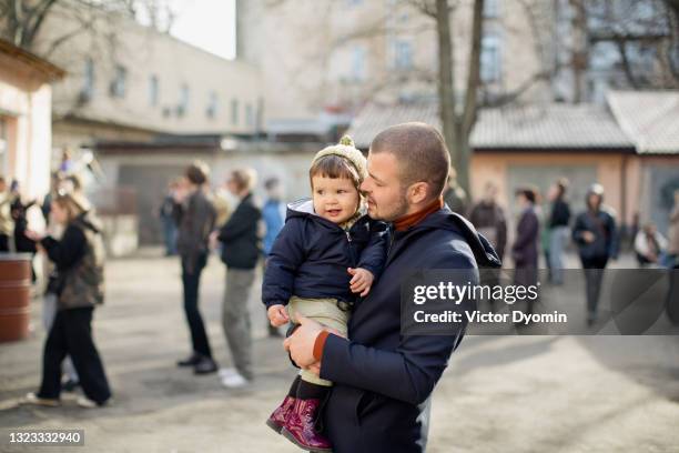 young father holds his little adorable daughter - ukraine people stock pictures, royalty-free photos & images