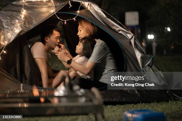 asian chinese family playing bonding inside camping tent at backyard - asian family camping stock pictures, royalty-free photos & images