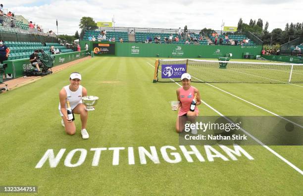 Johanna Konta of Great Britain holds the Viking Women's singles trophy and Shuai Zhang of China holds winners up trophy after the women's singles...