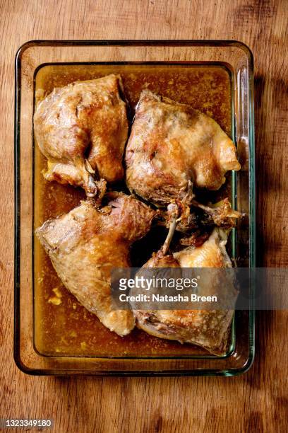 baked duck legs confit de canard in glass baking tray - confit stock pictures, royalty-free photos & images
