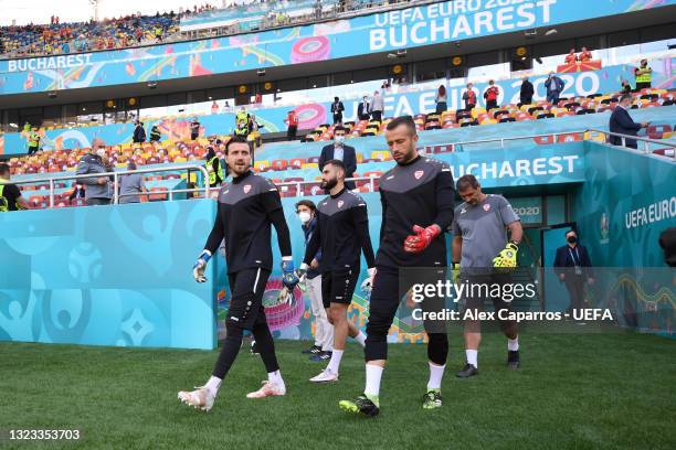 Stole Dimitrievski, Risto Jankov and Damjan Siskovski of North Macedonia make their way towards the pitch to warm up prior to the UEFA Euro 2020...