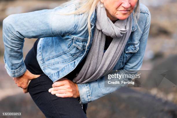 an active mature woman with hip pain - hip body part stock pictures, royalty-free photos & images