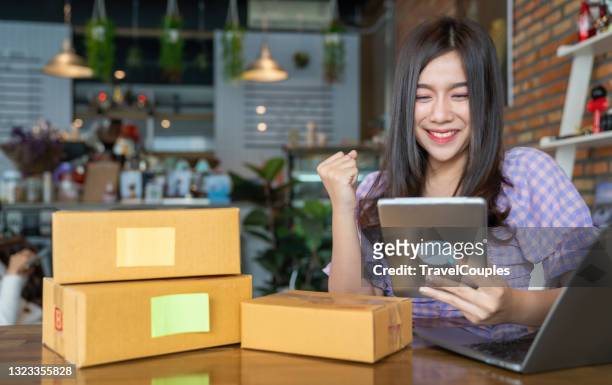 young business woman working selling online. surprise and shock face of asian woman success on making big sale of his online store.  online shopping - debit cards credit cards accepted stock pictures, royalty-free photos & images