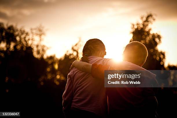 children with hand on shoulder - hand on shoulder stock pictures, royalty-free photos & images