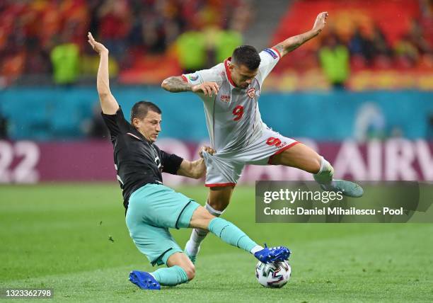 Aleksandar Trajkovski of North Macedonia is challenged by Stefan Lainer of Austria during the UEFA Euro 2020 Championship Group C match between...