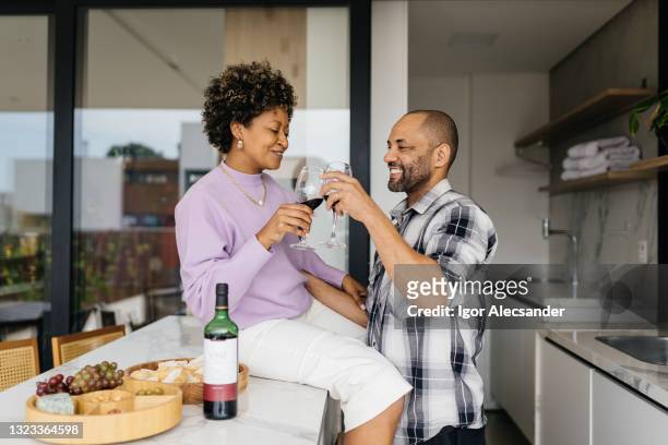 couple toasting at home - valentines couple stock pictures, royalty-free photos & images