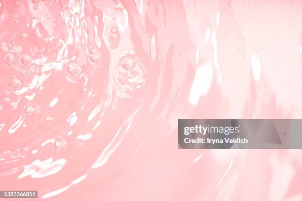 abstract background with moisturizing cleansing cosmetic gel, pure water or face serum, essential oil with oxygen aqua bubbles and waves. - vitamin drip stock pictures, royalty-free photos & images