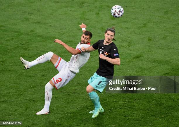 Egzon Bejtulai of North Macedonia battles for possession with Marcel Sabitzer of Austria during the UEFA Euro 2020 Championship Group C match between...