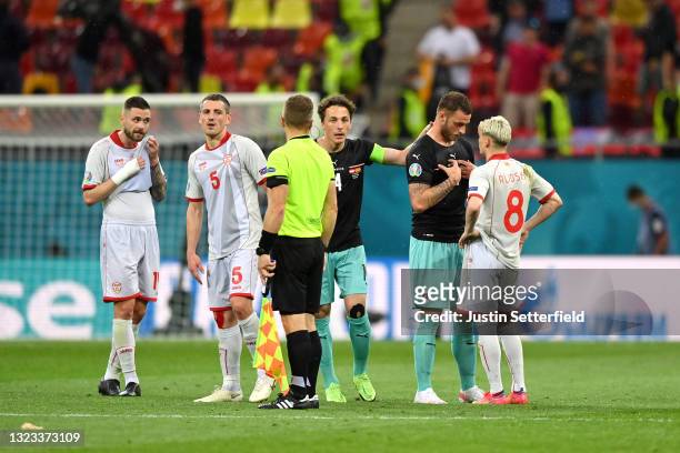 Marko Arnautovic of Austria clashes with Egzijan Alioski of North Macedonia during the UEFA Euro 2020 Championship Group C match between Austria and...
