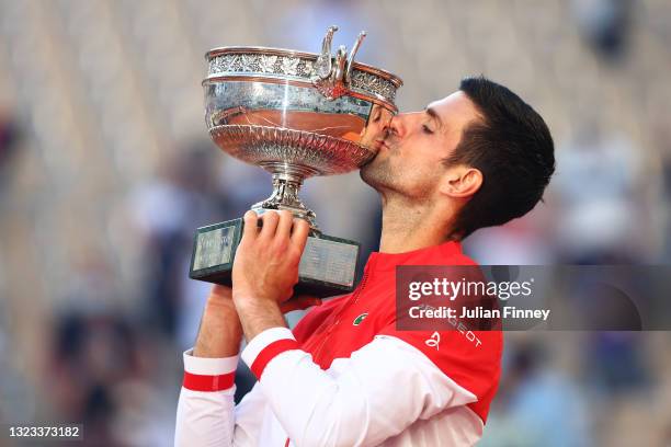 Novak Djokovic of Serbia celebrates as he kisses the trophy after winning his Men's Singles Final match against Stefanos Tsitsipas of Greece during...