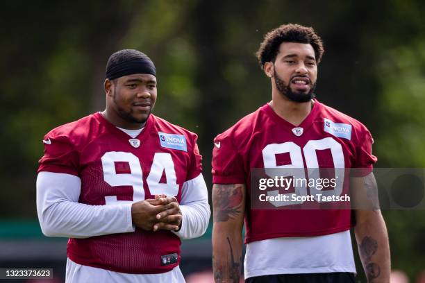 Montez Sweat and Daron Payne of the Washington Football Team look on during mandatory minicamp at Inova Sports Performance Center on June 10, 2021 in...