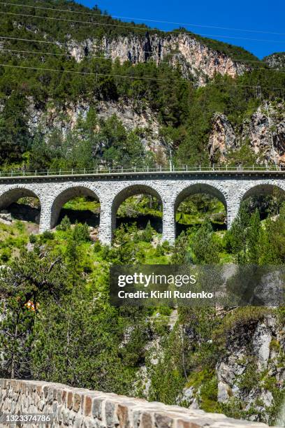 arched bridge in the swiss alps - arch bridge stock pictures, royalty-free photos & images