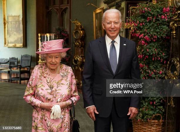 Queen Elizabeth II with US President Joe Biden in the Grand Corridor during their visit to Windsor Castle on June 13, 2021 in Windsor, England. Queen...