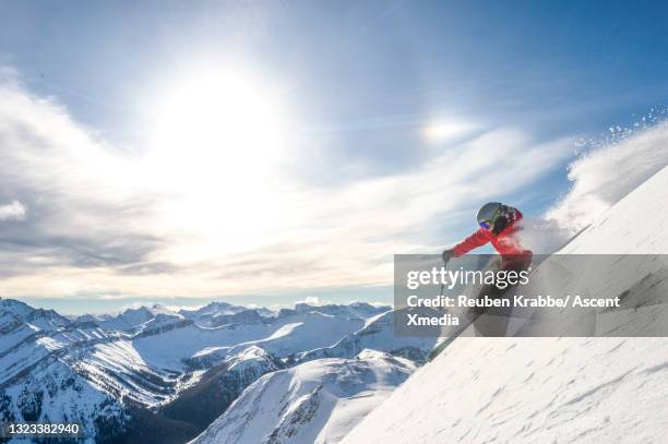 backcountry skier descends mountain through fresh powder snow - lake louise stock pictures, royalty-free photos & images