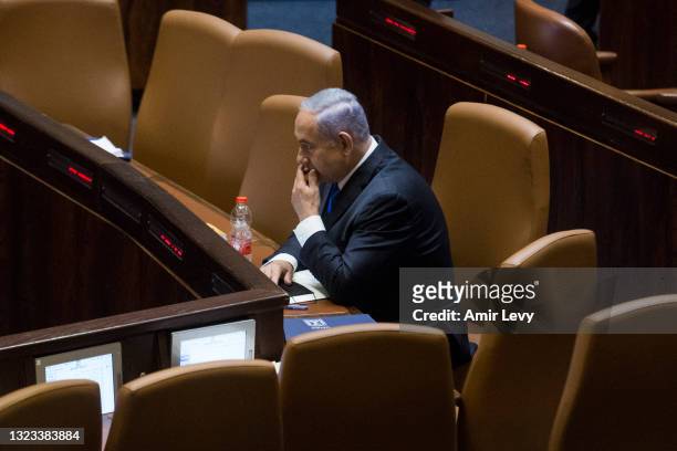 Israeli Prime Minister Benjamin Netanyahu look thoughtful as he sits in the Knesset before parliament votes to approve the new government on June 13,...